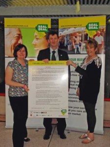 Pictured at the launch of the Real Deal in Oldham are (left to right): Samantha Fahmy Senior Market Officer; Kevin Welch (Principal Trading Standards Officer for Oldham Trading Standards; and market trader Linda Rogers of Hyde's Newsagents. 